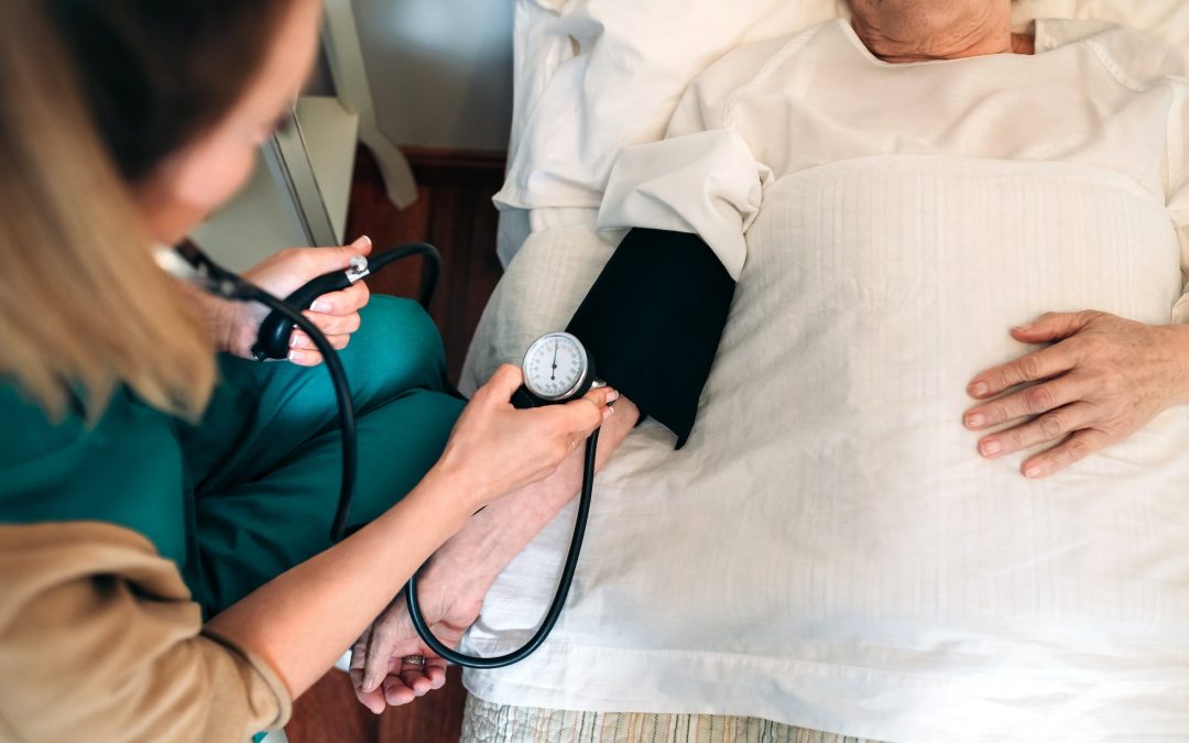 Caregiver checking blood pressure to a senior woman