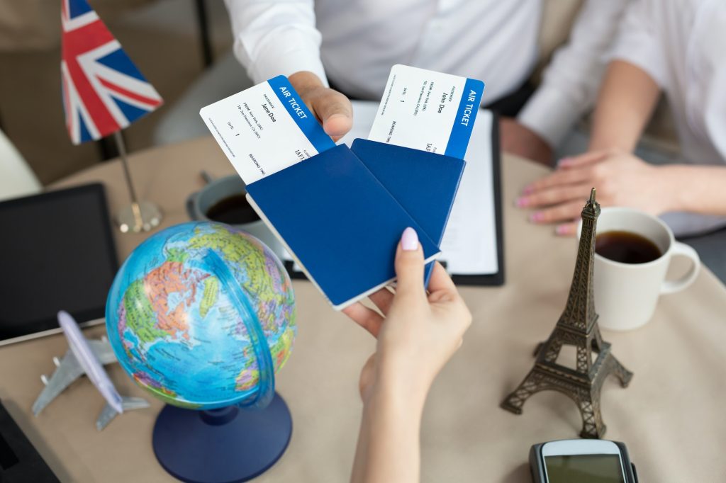 Close-up of passports and tickets in the hands of a travel agent in the office