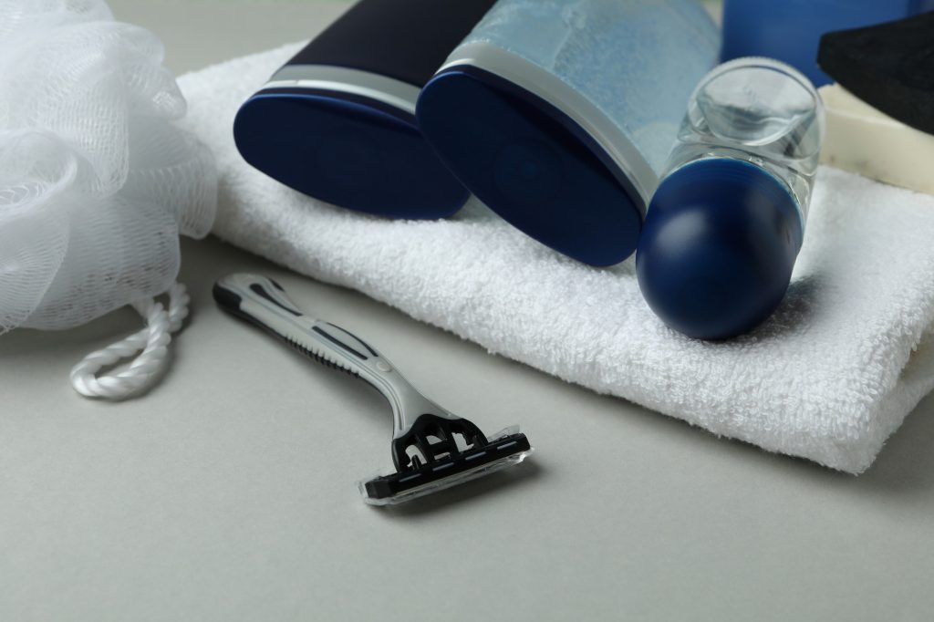 Concept of men's hygiene tools on light gray background