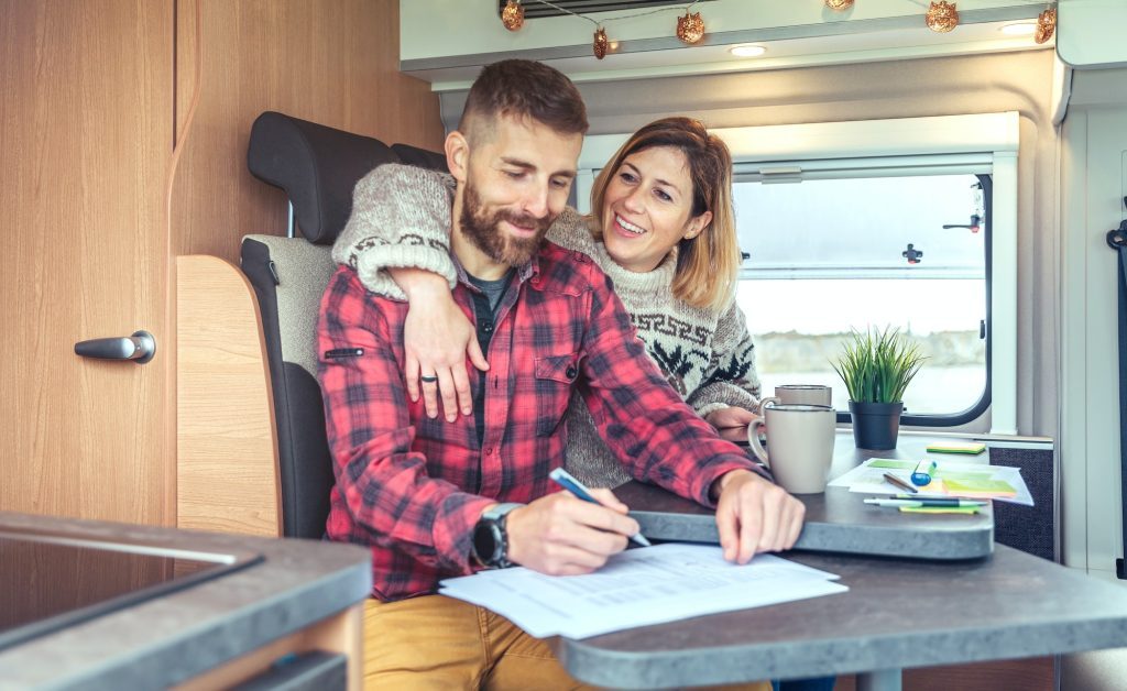 Couple telecommuting in a camper van