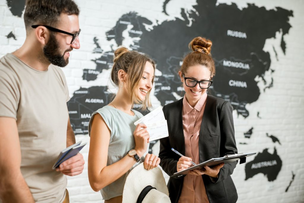 Couple with travel agent at the office