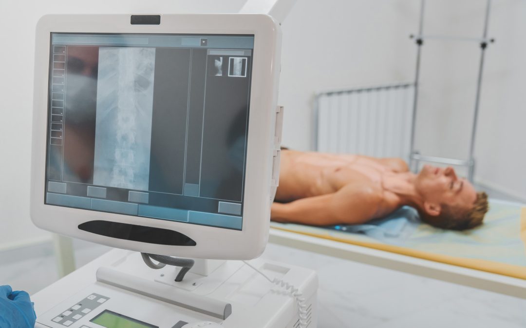 Doctor taking X-ray of patient lying on gurney