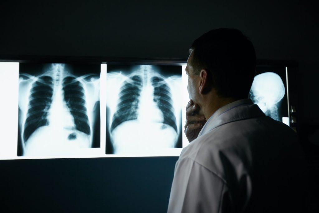 Doctor Working In Hospital During Examination Of X-rays