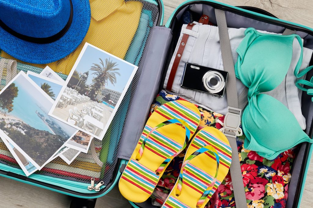 Essential beach things in suitcase