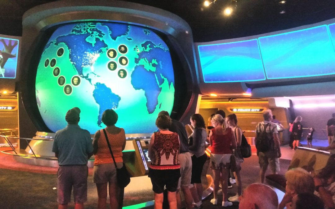 Family fun visiting a tourist attraction at Disney world with neon lights and world map of data.