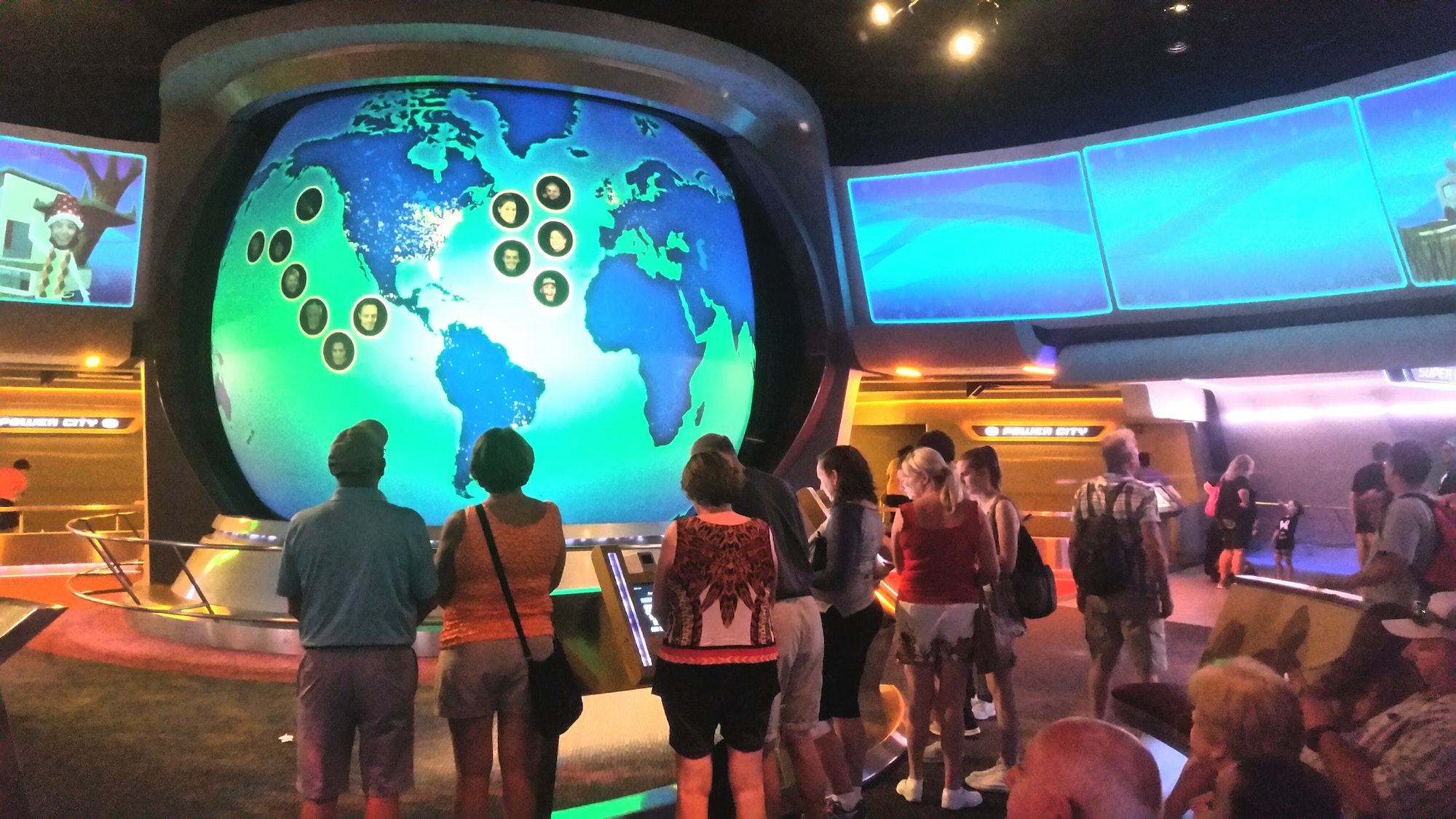 Family fun visiting a tourist attraction at Disney world with neon lights and world map of data.