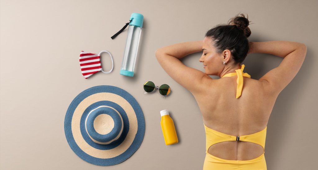 Flat lay top view of young woman with travel essentials, summer holiday concept