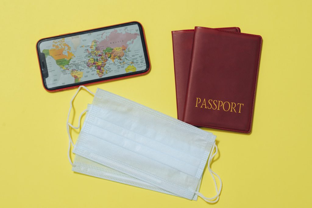 Flat lay travel with passports, Mobile phone, Medical masks.