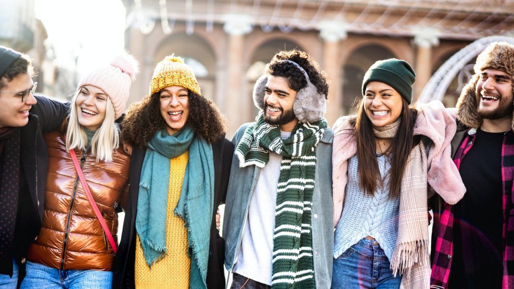 Happy students group walking at european city on sunny day