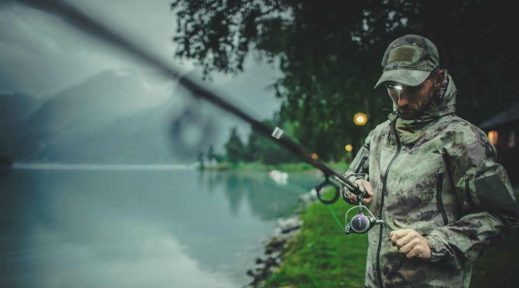 Men Preparing Rod For Late Evening Fishing