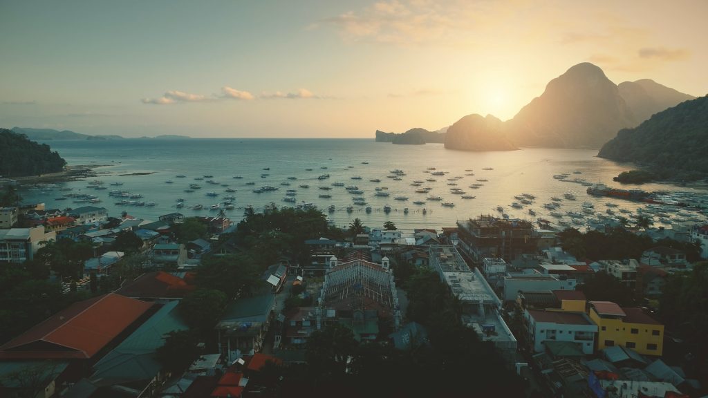 Ocean bay port with water transport at tropical cityscape. Paradise resort, Philippines islands