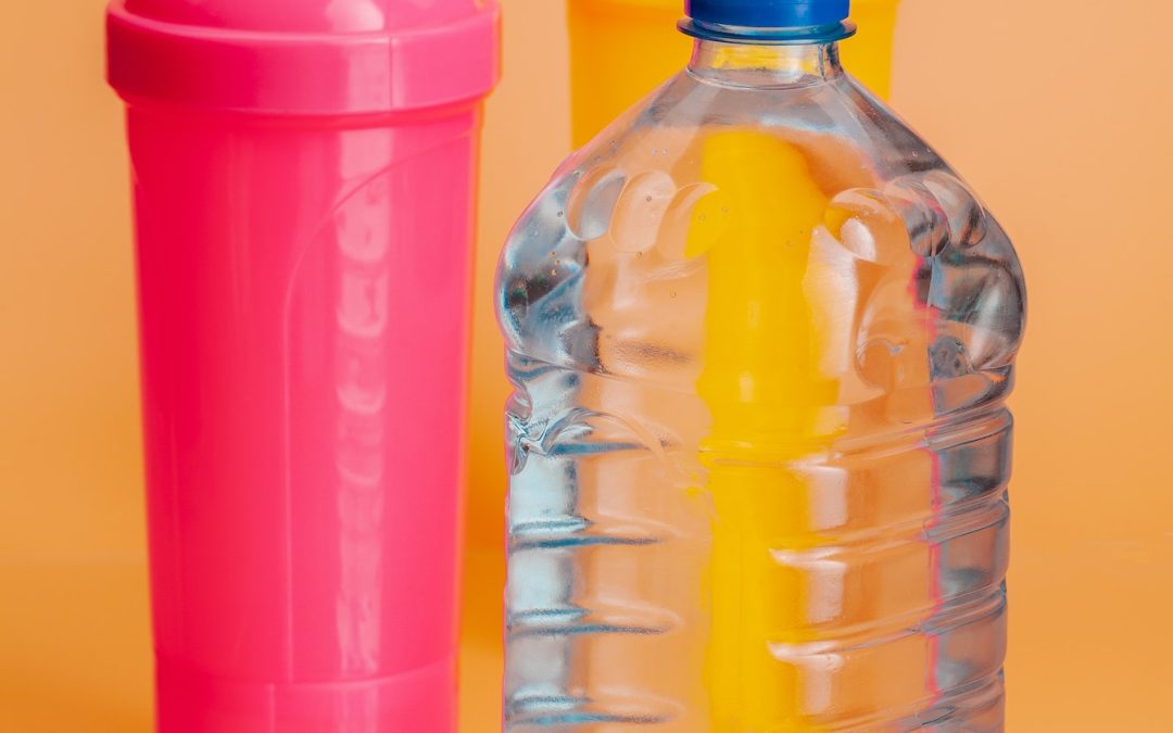 Plastic water bottles on a pastel beige background