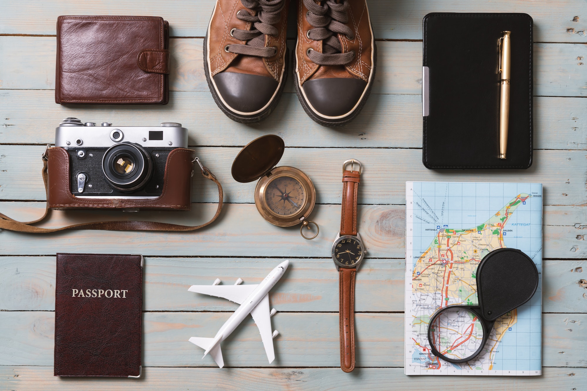 Set of traveler essentials on wooden background