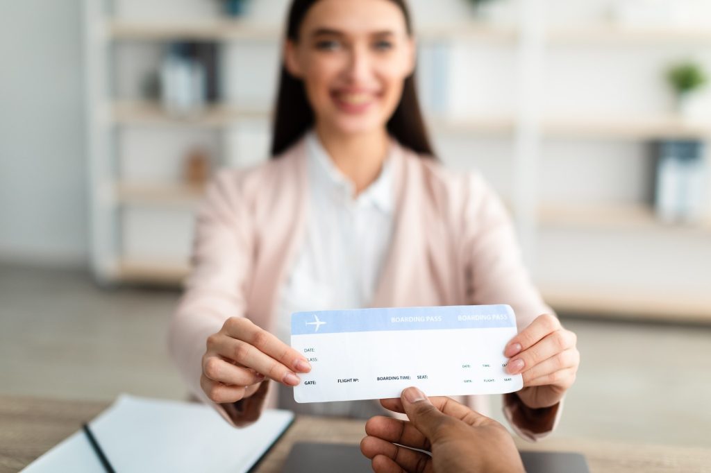 Travel Agent Giving Ticket To Client In Tour Agency Office