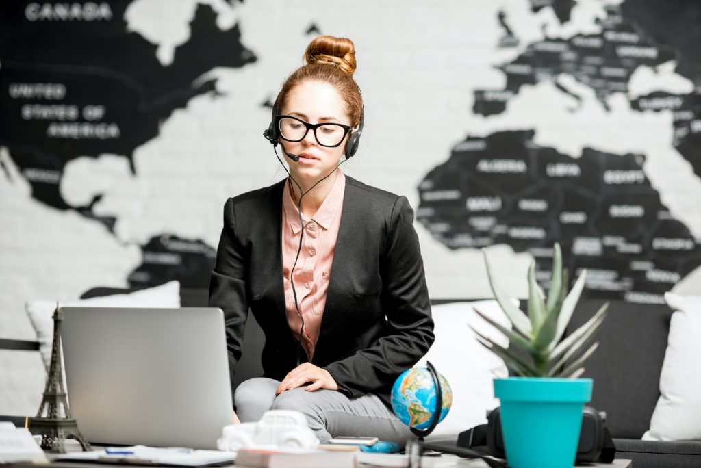 Travel agent portrait on the world map background