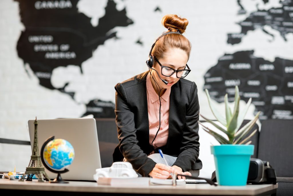 Travel agent portrait on the world map background