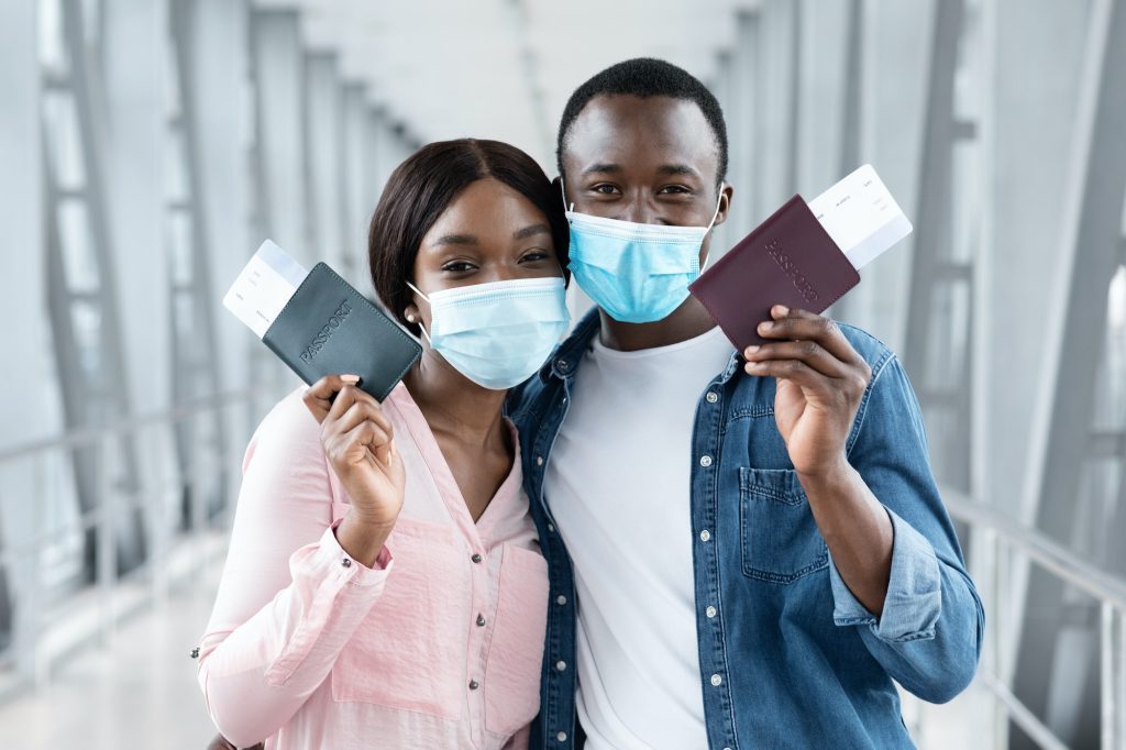 travel-safe-black-couple-in-medical-masks-posing-with-passports-at-airport-1024x682-2087592