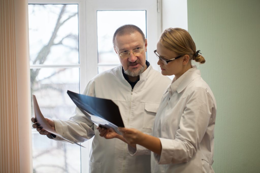 Two doctors analyzing x-ray images