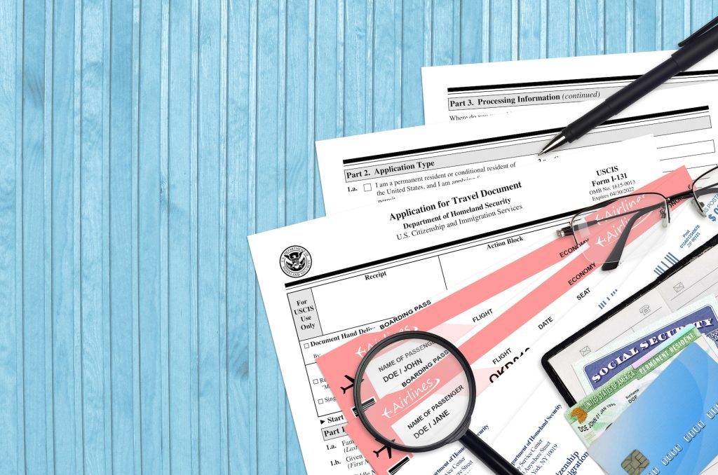 USCIS form I-131 Application for travel document lies on flat lay office table and ready to fill