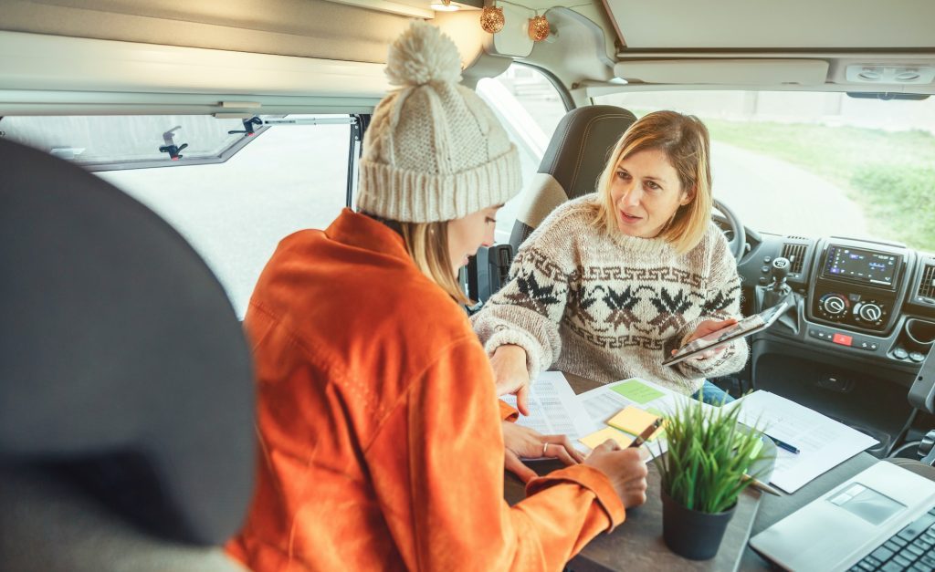 Women telecommuting in a camper van