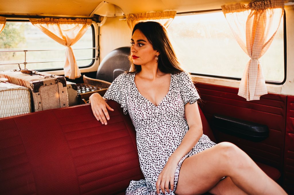 Young woman sitting in van